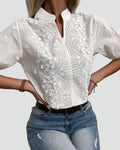 Elegant white blouse with floral embroidery and a stand-up collar
