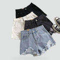 Women's raw denim jeans shorts with a high waist and distressing