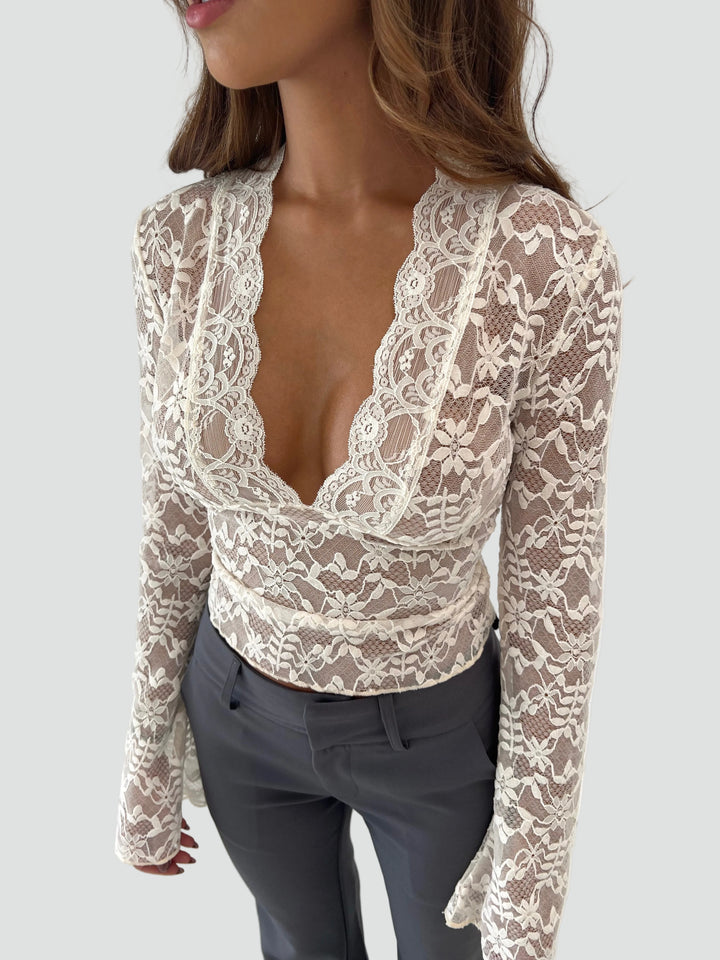 Lace blouse with a deep neckline and long sleeves