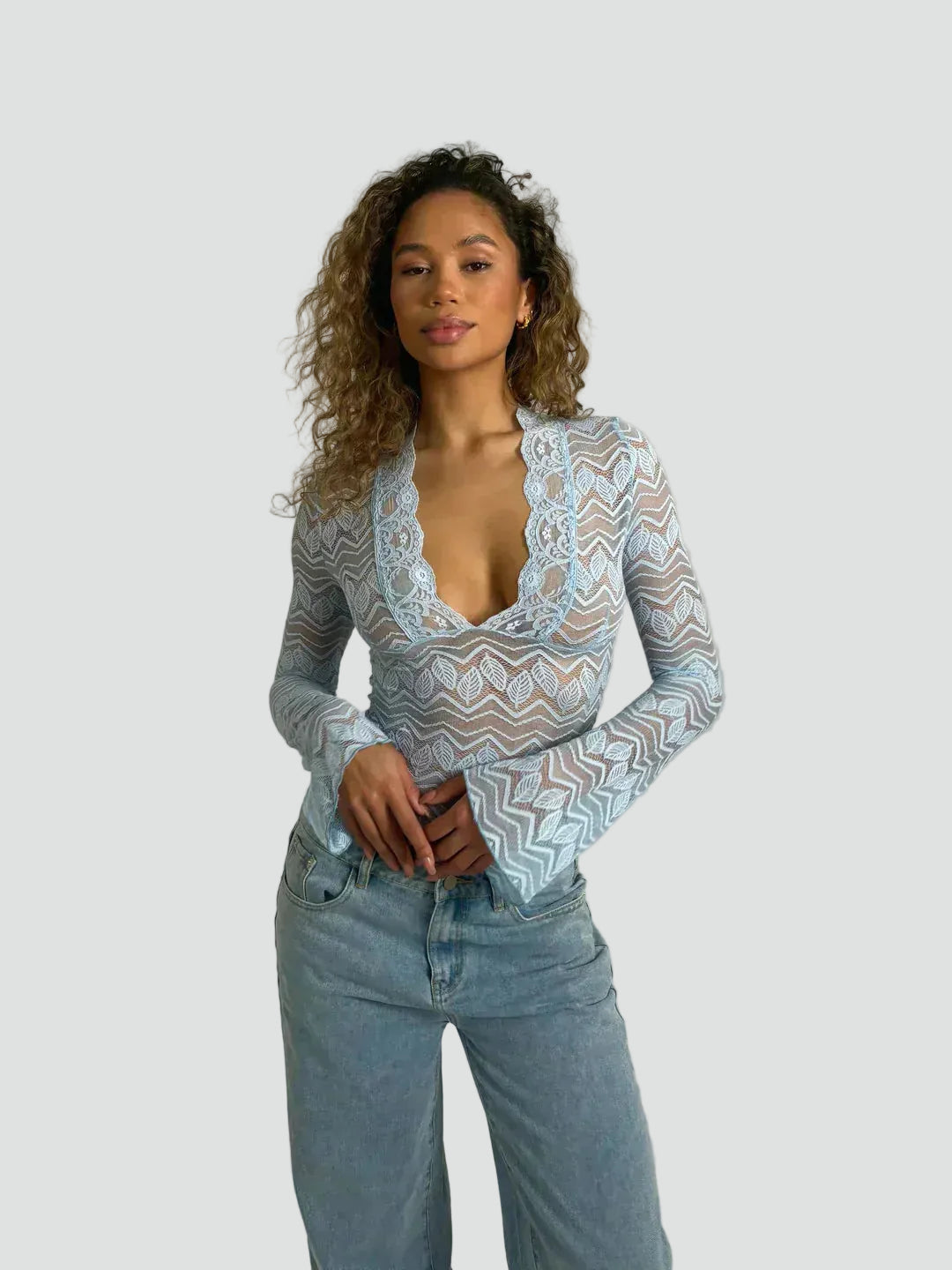 Lace blouse with a deep neckline and long sleeves