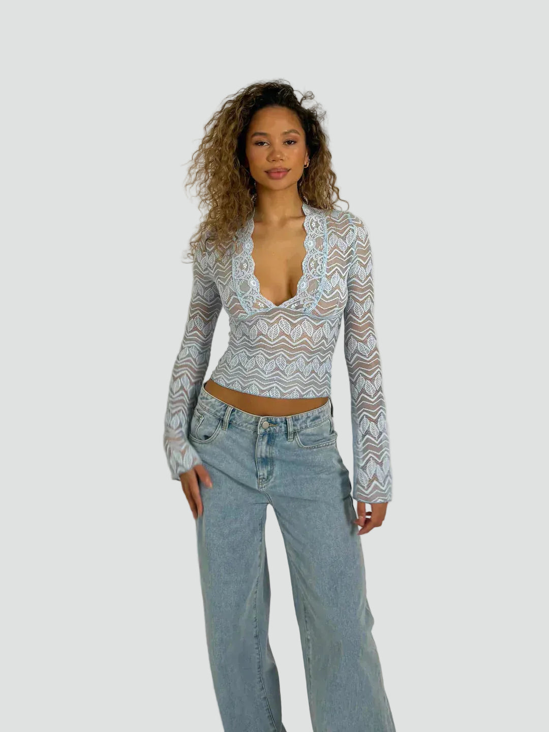 Lace blouse with a deep neckline and long sleeves