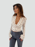 Lace blouse with a deep neckline and long sleeves