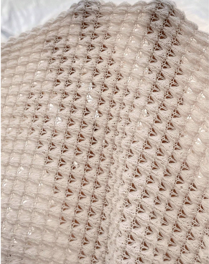 Beige knit blouse with V-neck and short sleeves