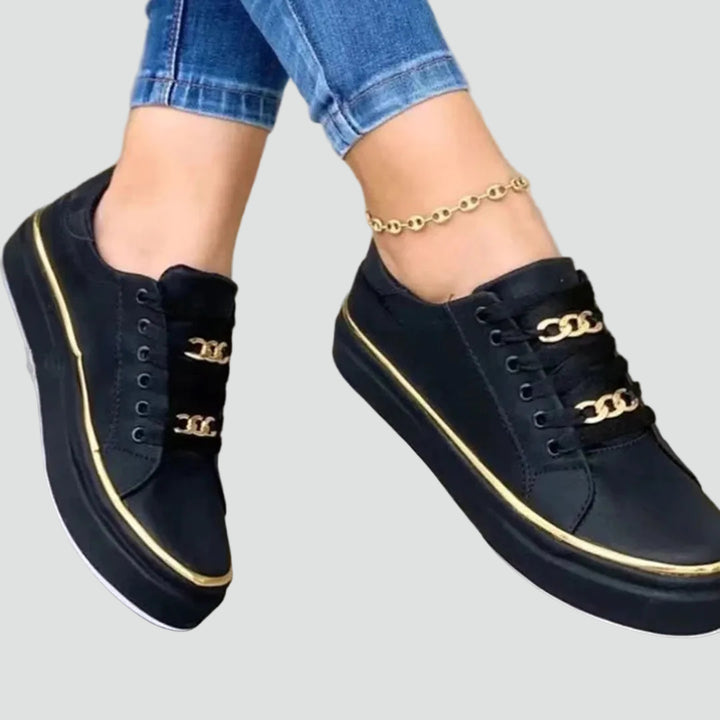 Stylish women's sneakers with a thick sole and decorative detail