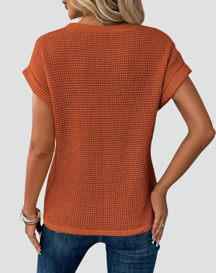 Knit top with short sleeves and a crossover hem