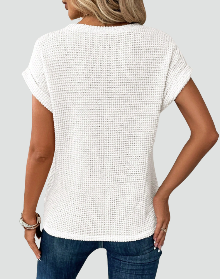 Knit top with short sleeves and a crossover hem