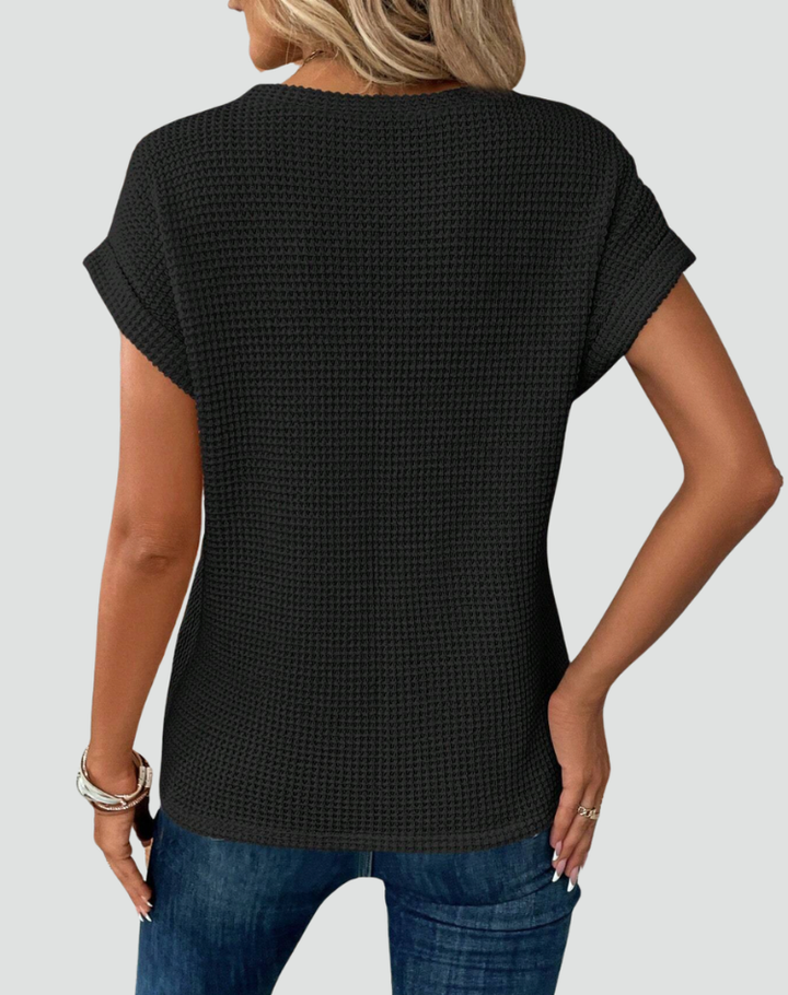 Knit top with short sleeves and a crossover hem