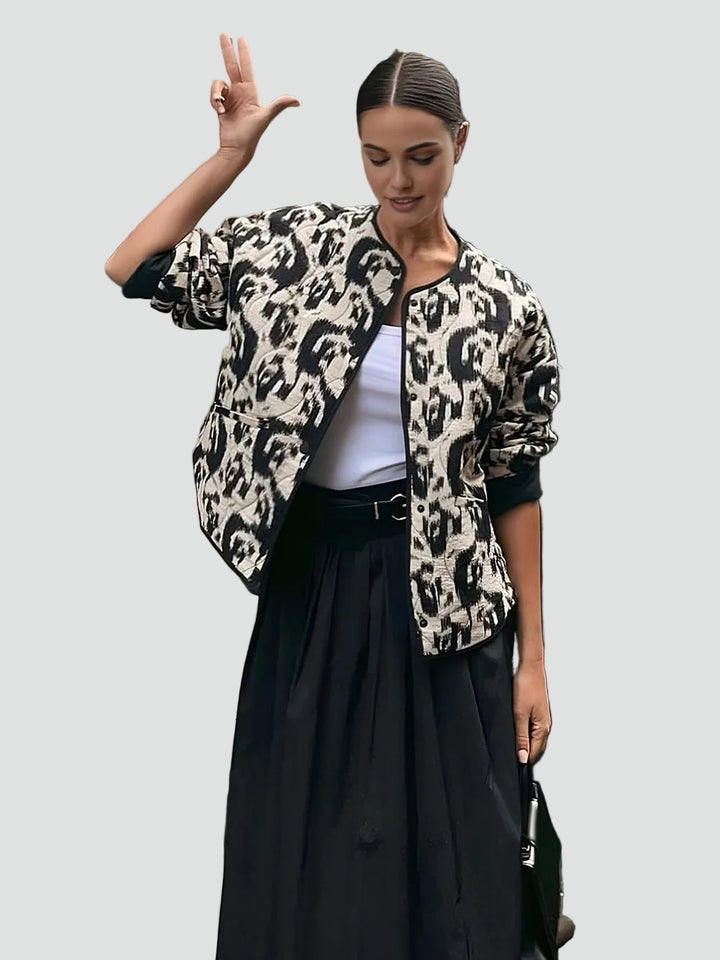 Patterned quilted jacket without collar with decorative trim