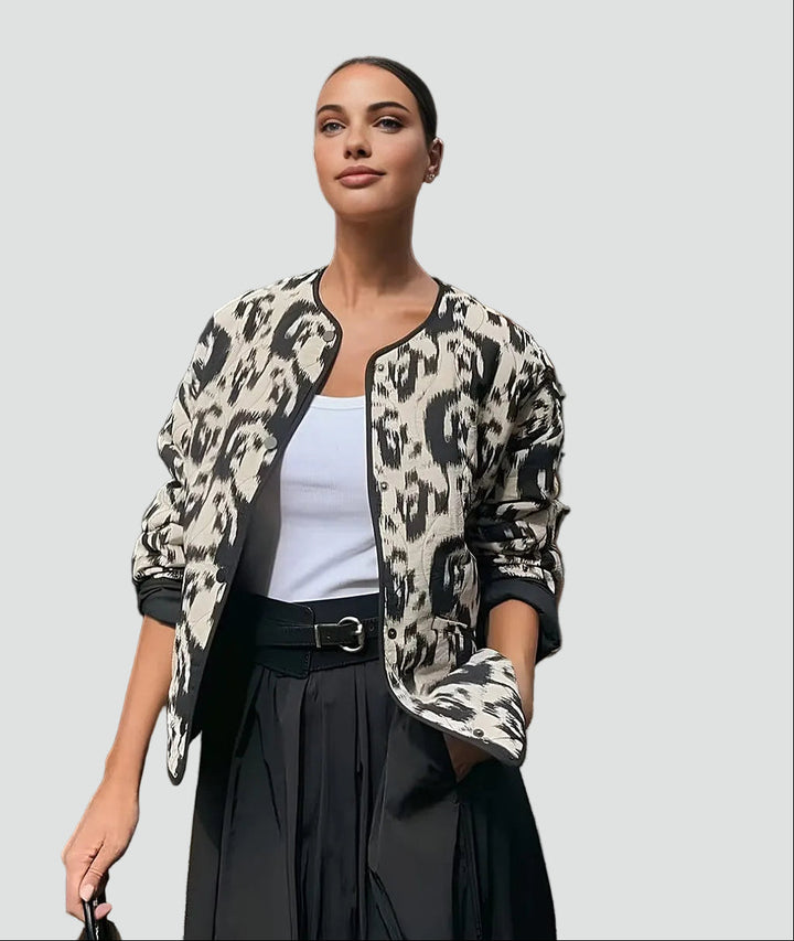 Patterned quilted jacket without collar with decorative trim