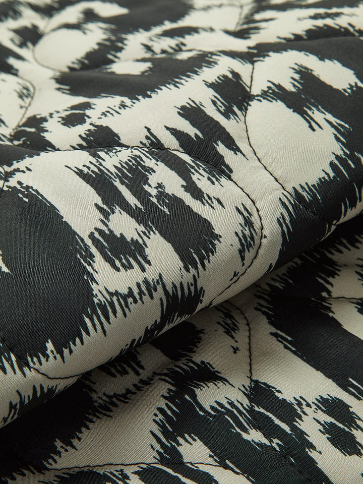 Patterned quilted jacket without collar with decorative trim