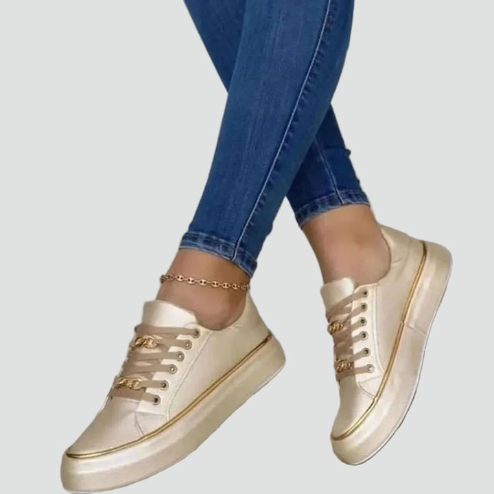 Stylish women's sneakers with a thick sole and decorative detail