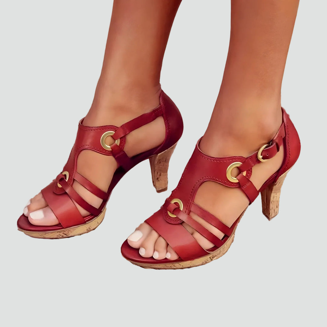 Heeled sandals with straps and decorative metal details