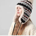 Warm women's winter ushanka hat with a Norwegian pattern and fur trim
