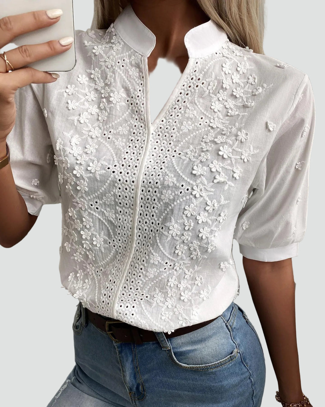 Blouse blanche élégante avec broderie florale et col montant