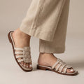 Women's slide sandals with braided straps and a flat sole