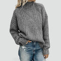 Women’s pullover sweater with a cable-knit design and a relaxed fit